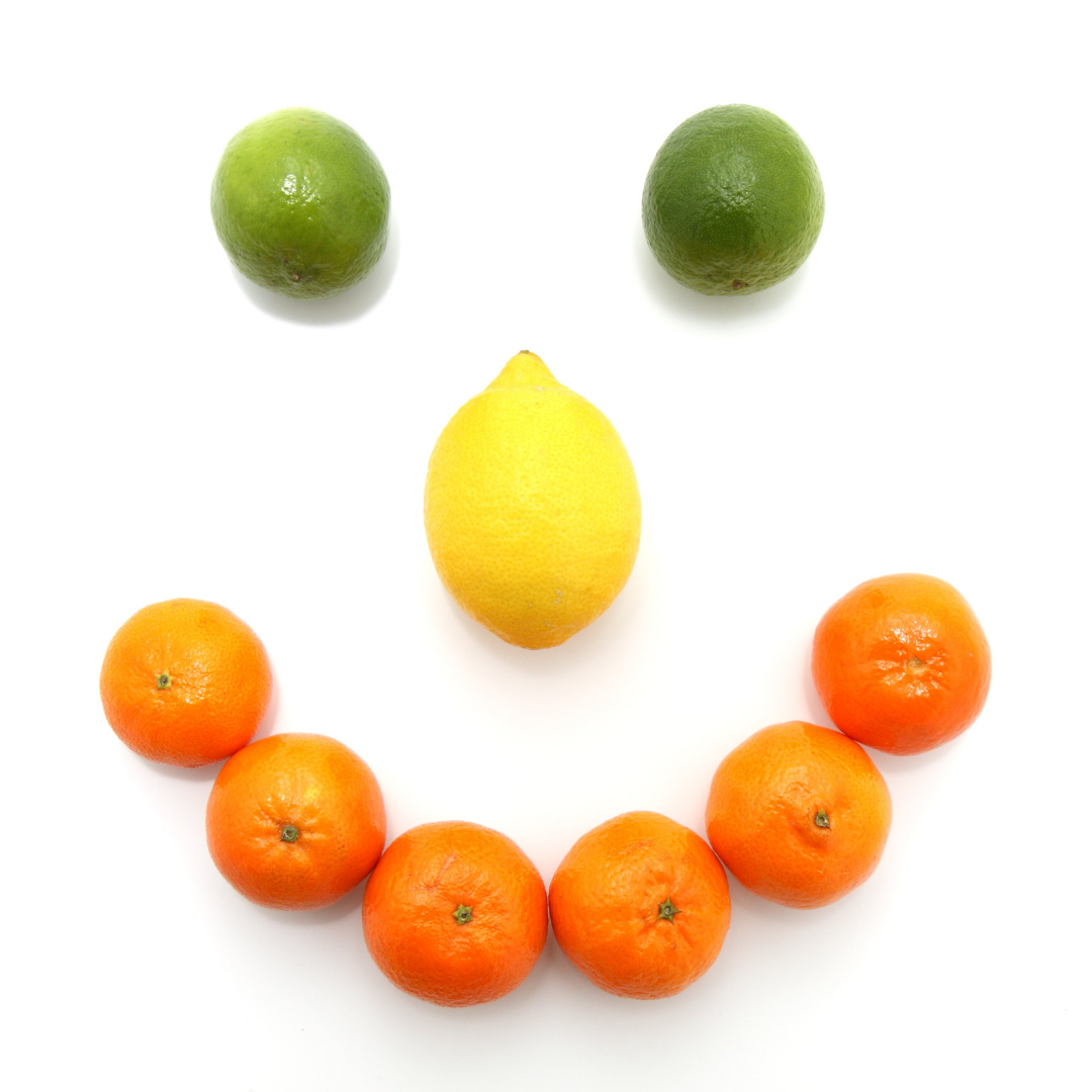 smiley face made from limes lemon and oranges